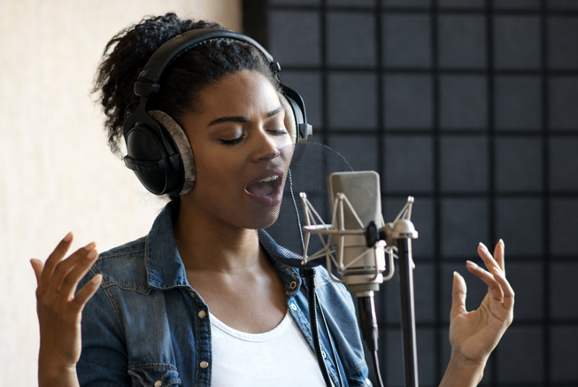 Woman on microphone recording song